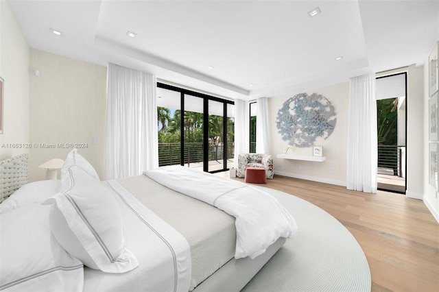 5327 N Bay Rd, Miami Beach, FL 33140 - bedroom with access to outside, wood finished floors, and baseboards