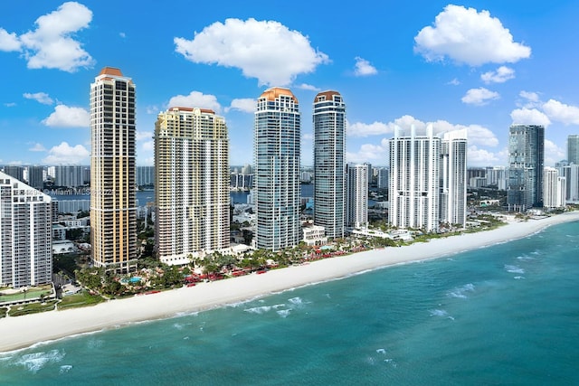 birds eye view of property featuring a beach view and a water view