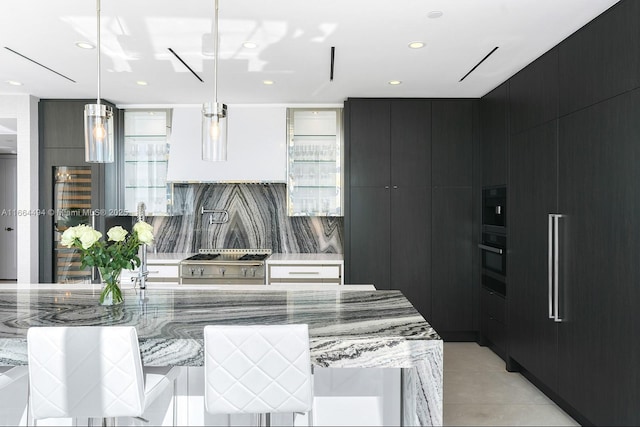 kitchen with custom range hood, high end stainless steel range oven, modern cabinets, dark cabinets, and oven