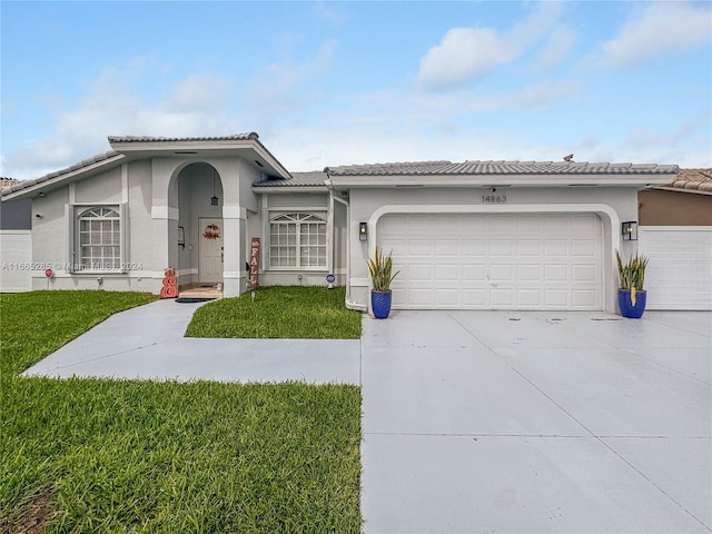 view of front of house with a front yard and a garage