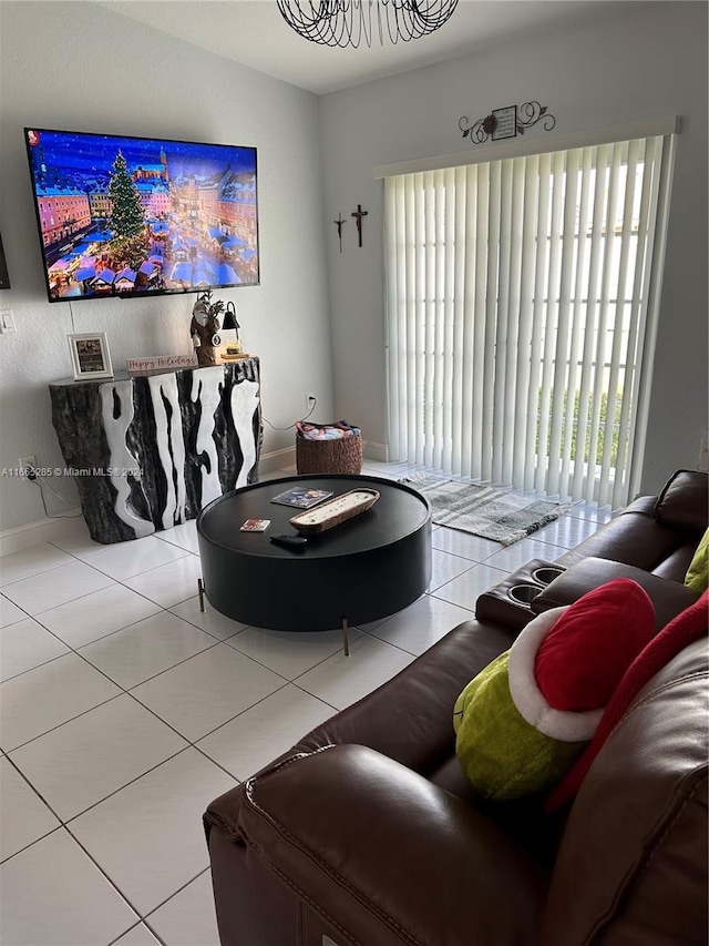 tiled living room featuring plenty of natural light and an inviting chandelier