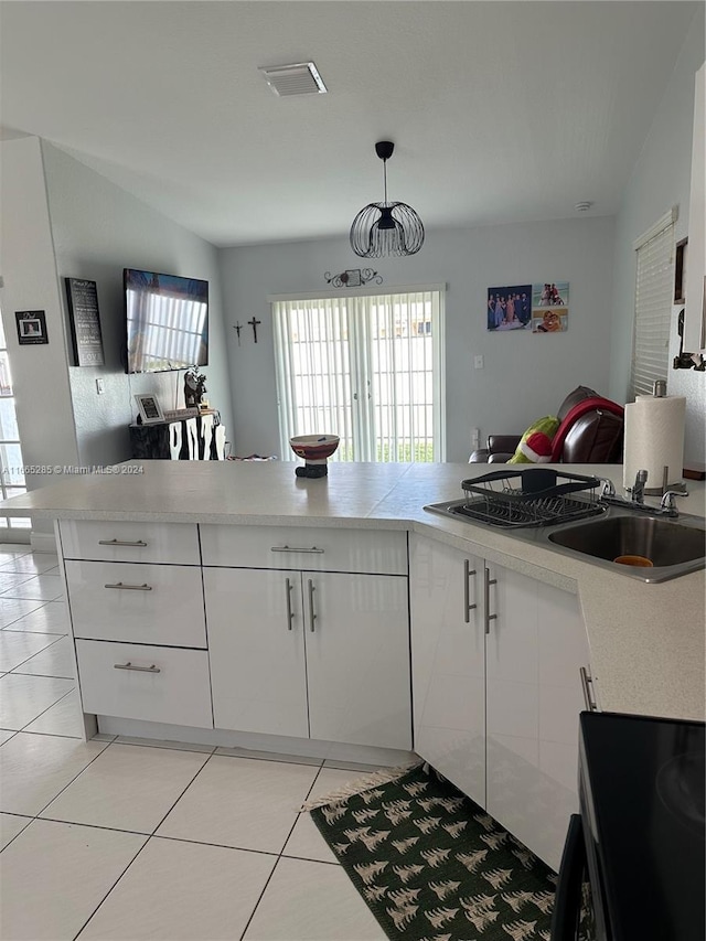 kitchen with lofted ceiling, a healthy amount of sunlight, and white cabinetry