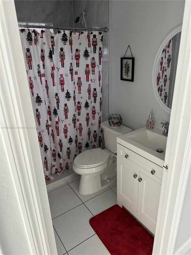 bathroom with tile patterned flooring, vanity, and toilet