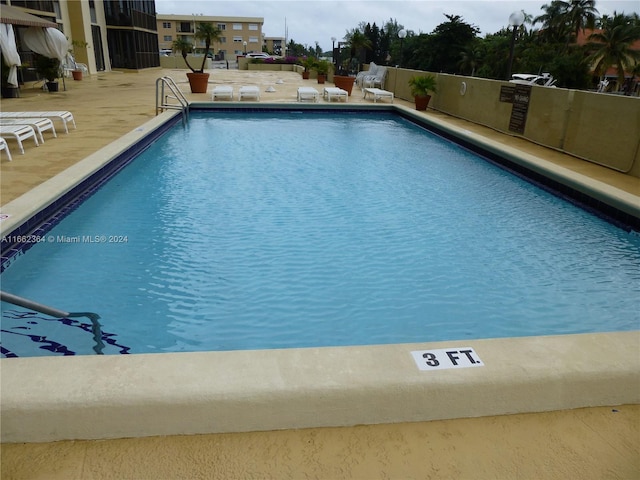 view of swimming pool featuring a patio area