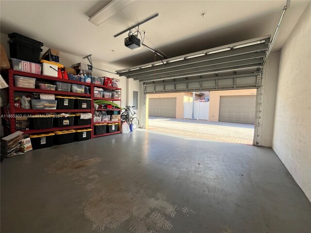 garage with electric panel and a garage door opener