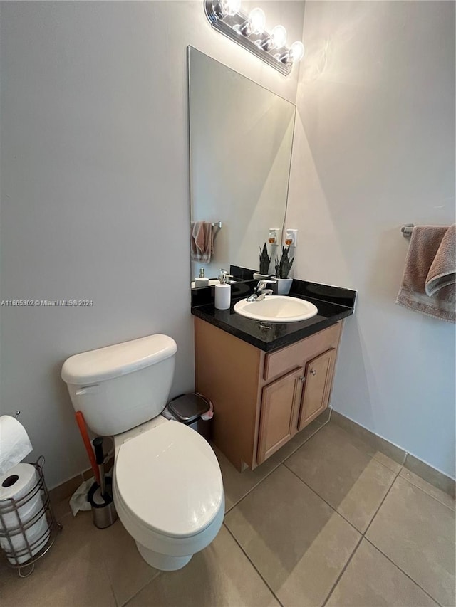 bathroom with vanity, toilet, and tile patterned floors