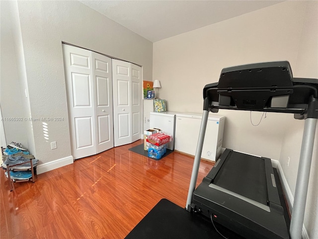 exercise room featuring light wood-type flooring