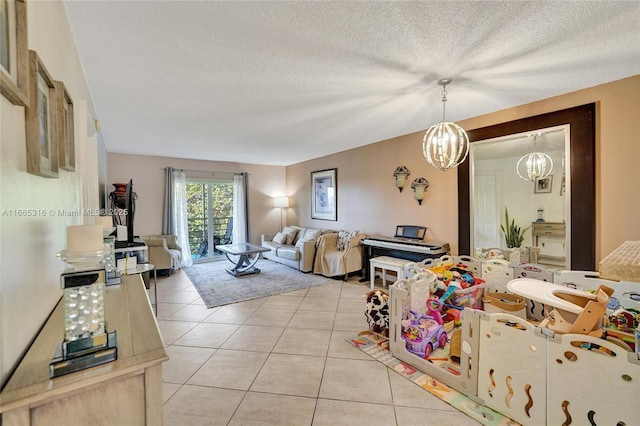 living area with light tile patterned flooring, a textured ceiling, and an inviting chandelier