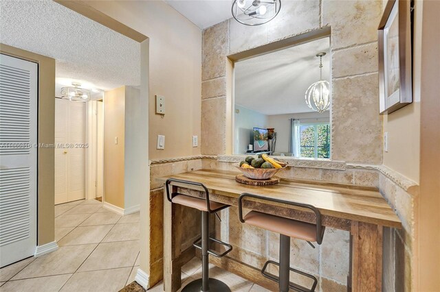 kitchen featuring light tile patterned floors and stainless steel appliances