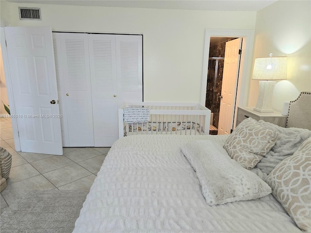 tiled bedroom featuring a closet