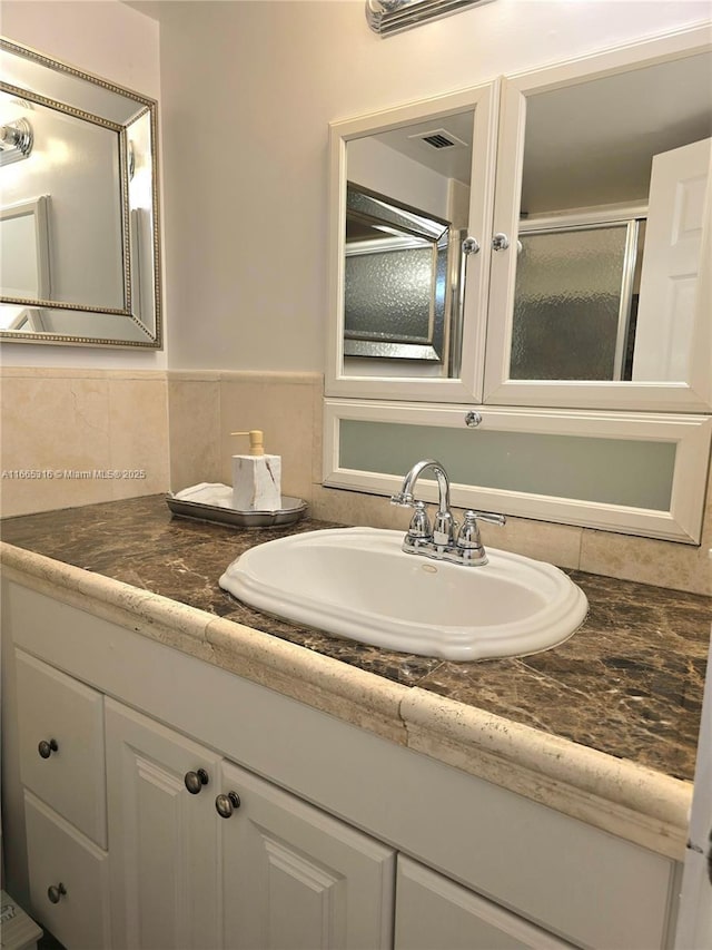 bathroom with vanity and walk in shower