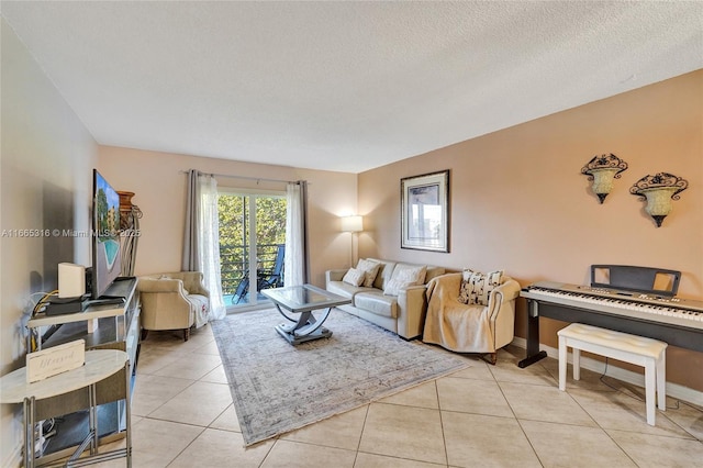 living area with light tile patterned floors, baseboards, and a textured ceiling