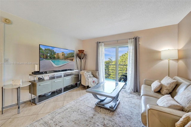 living room featuring a textured ceiling and light tile patterned floors