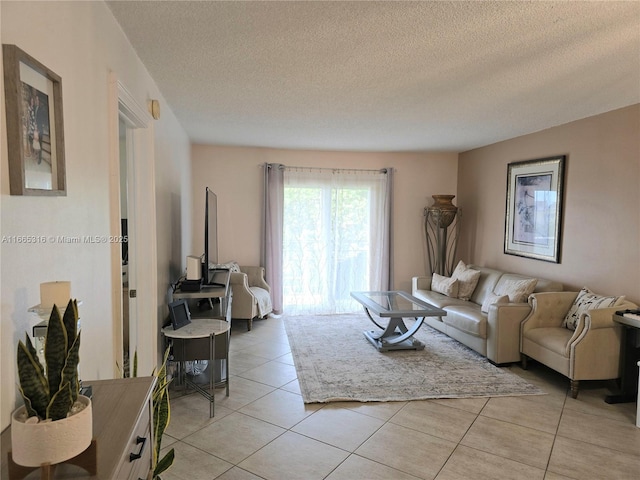 tiled living room featuring a textured ceiling