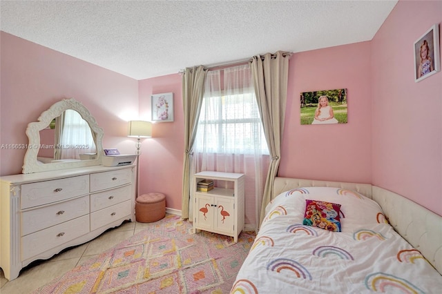 bedroom featuring light tile patterned flooring and a textured ceiling