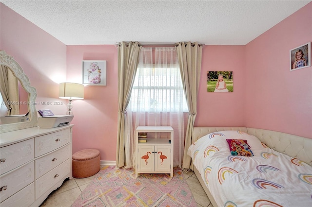 bedroom with a textured ceiling and light tile patterned floors