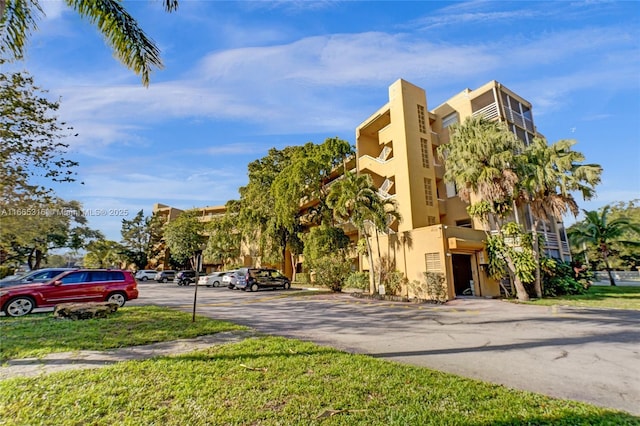 view of property with uncovered parking