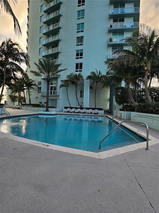 view of pool at dusk