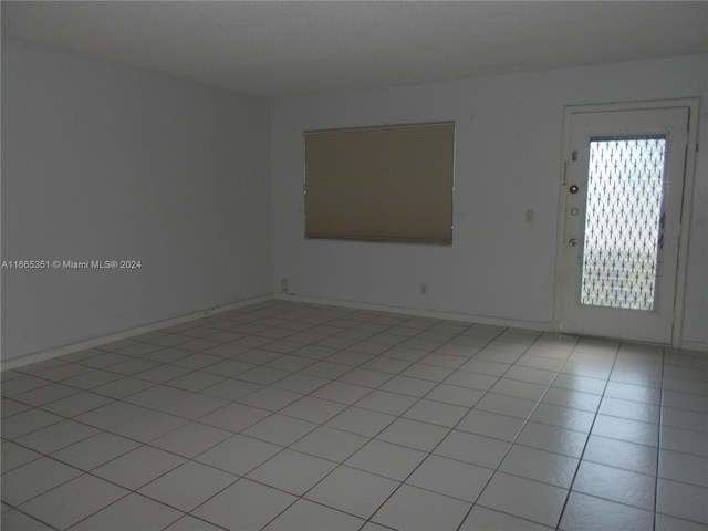 unfurnished room featuring light tile patterned floors