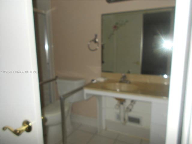 bathroom featuring tile patterned flooring and toilet