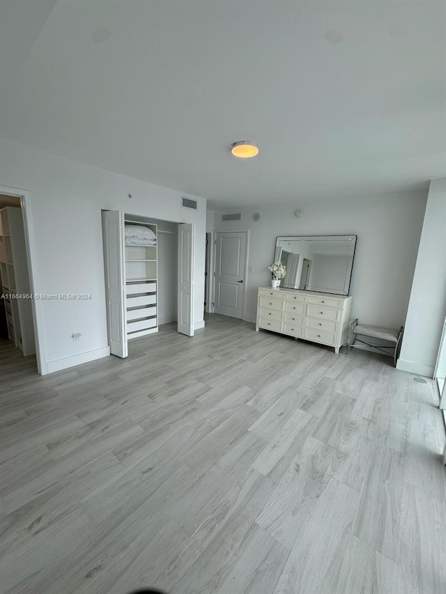 unfurnished living room with light wood-type flooring