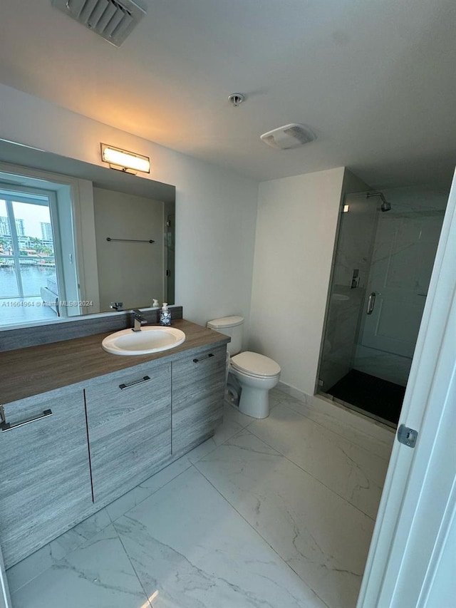 bathroom featuring vanity, toilet, and a shower with door