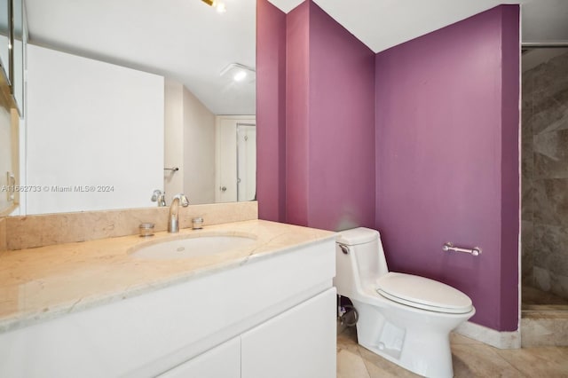 bathroom with walk in shower, vanity, tile patterned flooring, and toilet