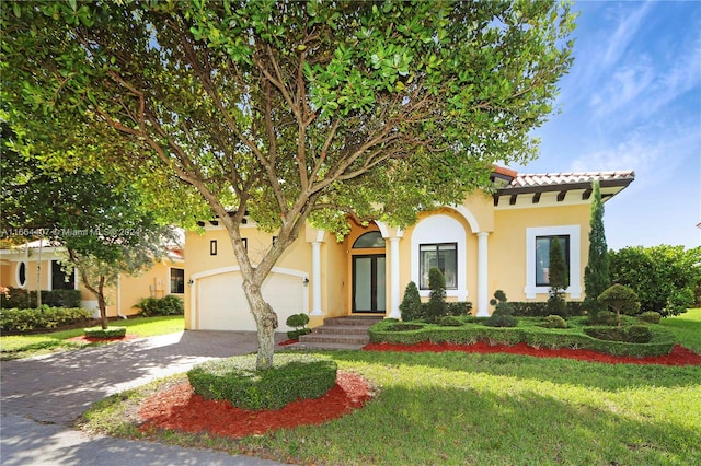 view of front of property featuring a garage and a front lawn