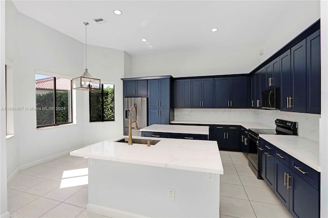 kitchen with pendant lighting, a kitchen island with sink, light tile patterned floors, and stainless steel appliances