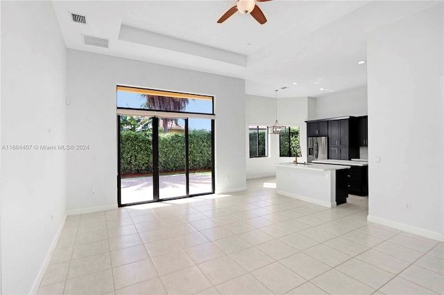 interior space with ceiling fan and a tray ceiling