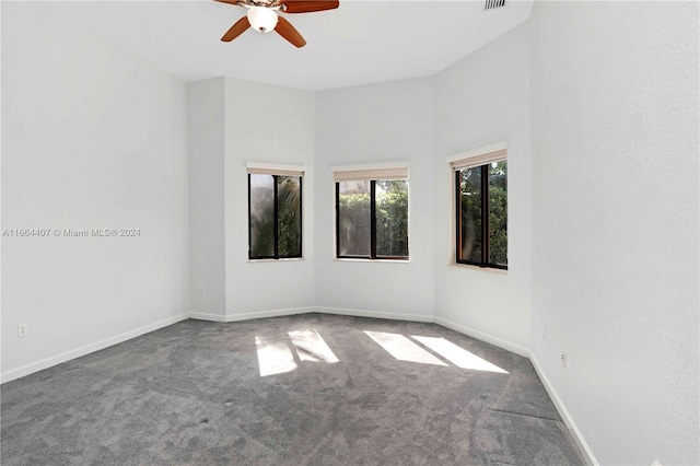 carpeted spare room featuring ceiling fan