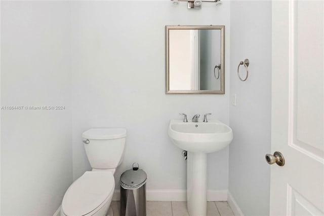 bathroom with tile patterned flooring, toilet, and sink