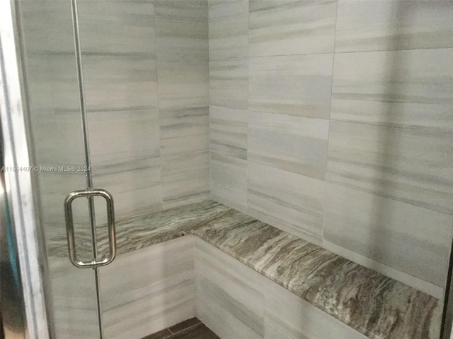 bathroom featuring a shower with shower door