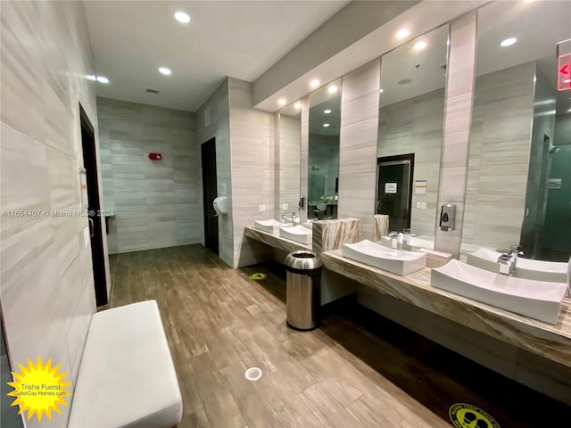 bathroom featuring vanity, tile walls, and wood-type flooring