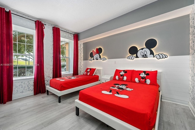 bedroom featuring a textured ceiling and hardwood / wood-style floors