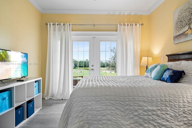 bedroom featuring ornamental molding, hardwood / wood-style flooring, access to exterior, and french doors