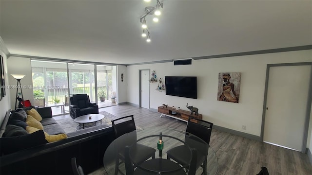 living room with crown molding and hardwood / wood-style floors