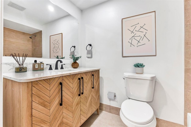 bathroom featuring tile patterned floors, vanity, and toilet