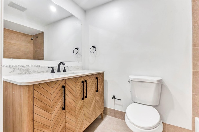 bathroom featuring vanity, toilet, and tile patterned floors