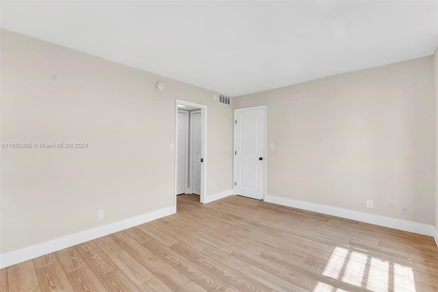 empty room with light hardwood / wood-style flooring