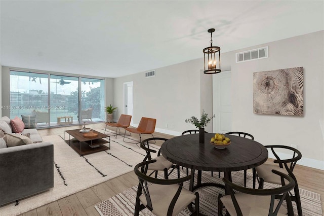 dining room with an inviting chandelier and light wood-type flooring