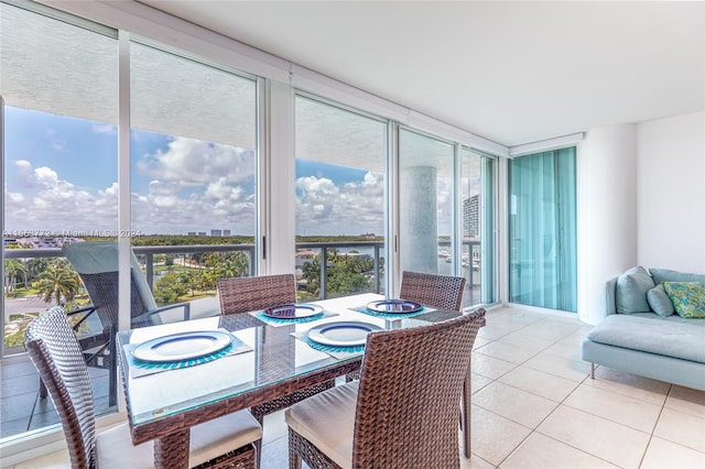 dining space featuring floor to ceiling windows and light tile patterned floors