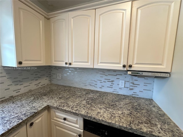 kitchen with white cabinetry, decorative backsplash, and light stone countertops