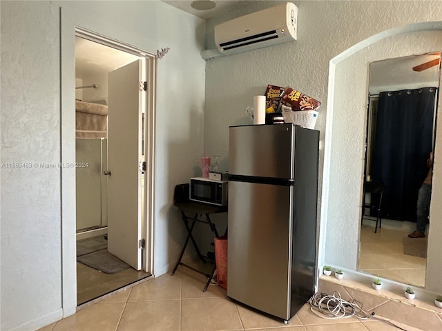 interior space featuring a shower, an AC wall unit, and tile patterned floors