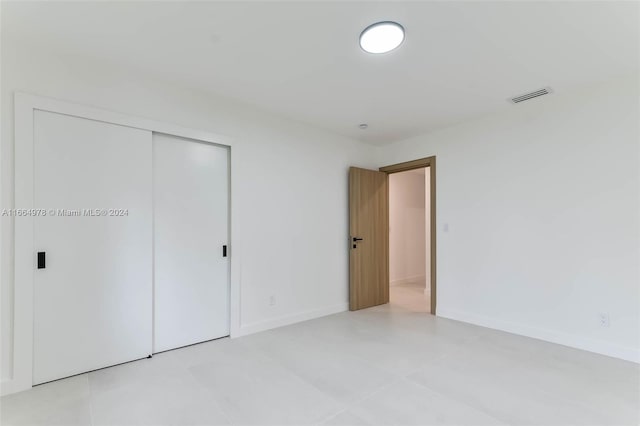 unfurnished bedroom featuring a closet and tile patterned flooring