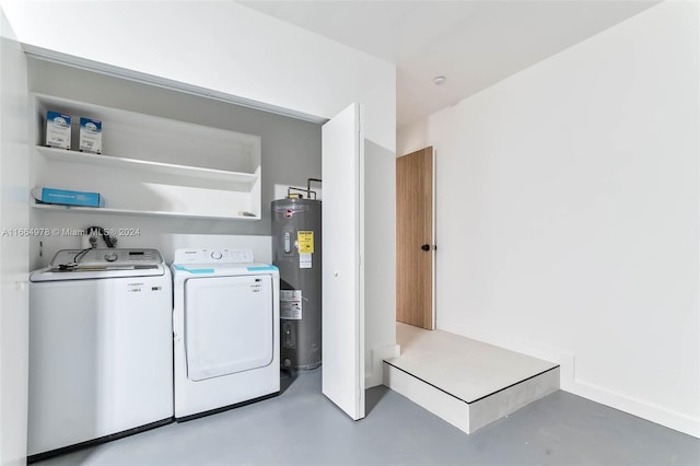 laundry area with electric water heater and washing machine and clothes dryer