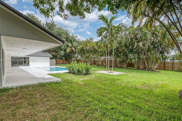 view of yard with a fenced in pool and a patio area