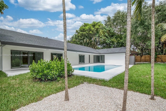 view of swimming pool with a yard and a patio area