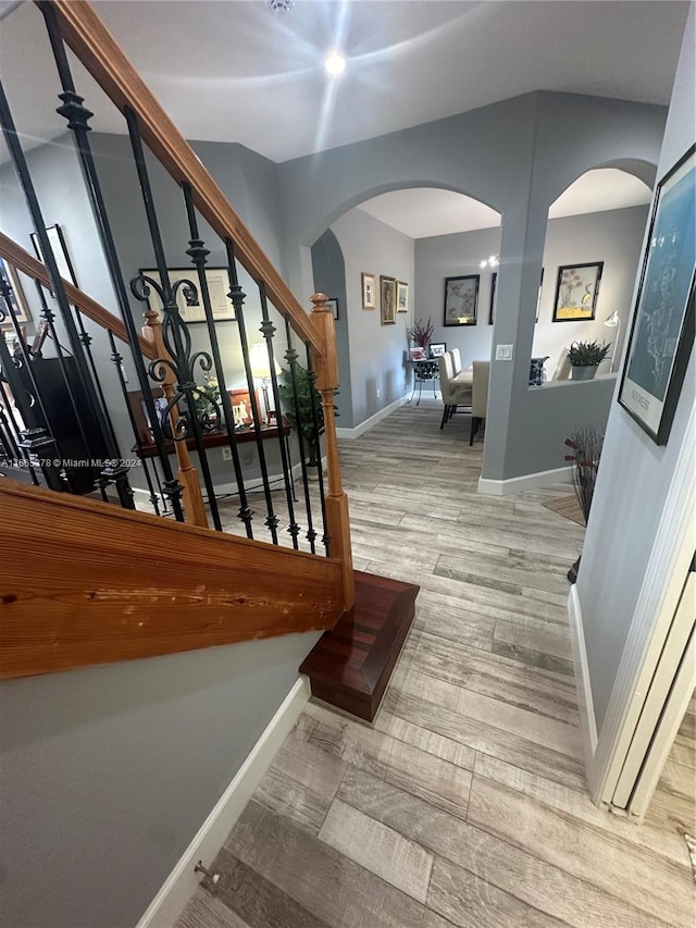 staircase with wood-type flooring