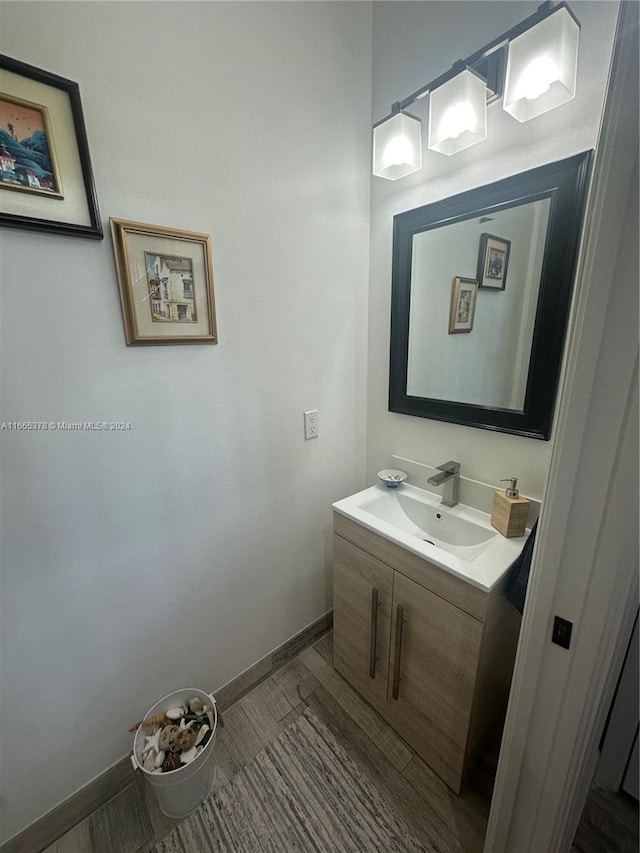 bathroom with hardwood / wood-style floors and vanity